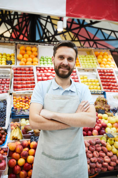 istock Content handsome retailer with beard against fresh food shelves 1063716552