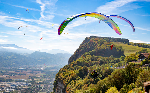 Paraglider pilots fly on September 22, 2018 in Saint-Hilaire-du-Touvet, south-eastern France, during the 45th Icarus cup. Created in 1974, the Coupe Icare (Icarus Cup) is the oldest 'free flight' festival in the world. It brings together more than 8.000 pilots of all kinds of aircrafts, from paragliders and hang gliders to hot air balloons and even a man in a jet-propelled suit. In this photo, paragliders make an exhibition fly.