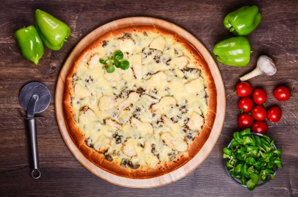 istock Pizza on a table of dark wood 1063719202