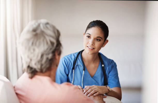 I'm here to assist with anything you need Cropped shot of an attractive young nurse holding a senior woman's hands in comfort female nurse stock pictures, royalty-free photos & images