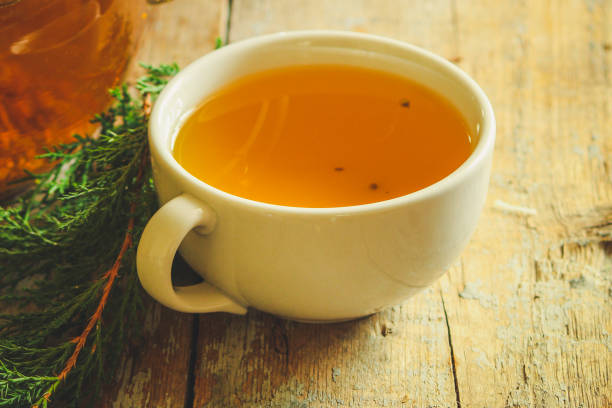 istock tea in a transparent teapot on the table (herbal tea is brewed). top view. 1063724284