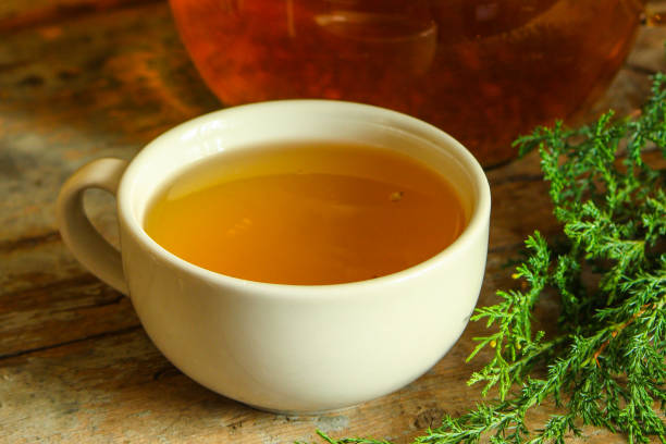 istock tea in a transparent teapot on the table (herbal tea is brewed). top view. 1063724294
