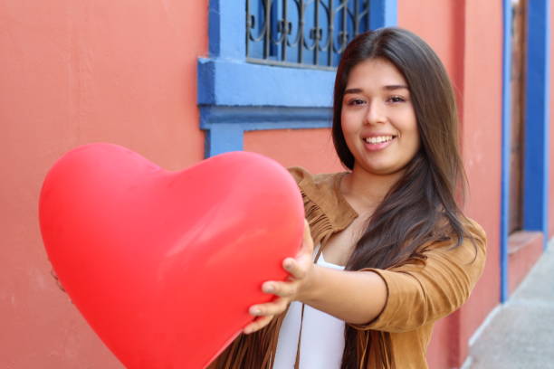 istock Female giving a red big heart 1063724656