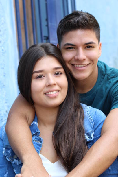 Young couple cuddling close up