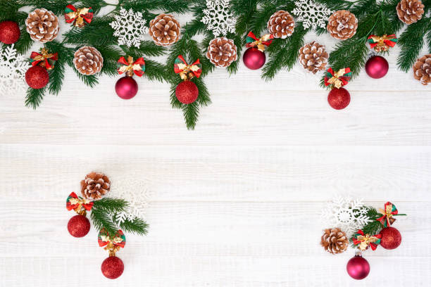 Festive composition of Christmas decorations on white wooden background.