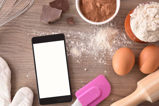 istock Pastry ingredients and technology on wooden with mobile top 1063731138