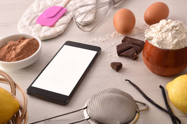 istock Pastry ingredients on white wooden table and mobile elevated 1063731154
