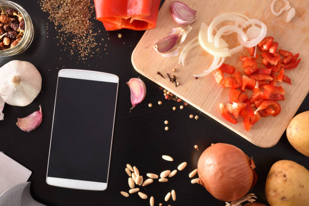 istock Preparation of vegetables on black wooden table with mobile top 1063731182