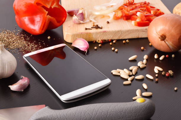 istock Preparation of vegetables on black wooden table with mobile elevated 1063731184