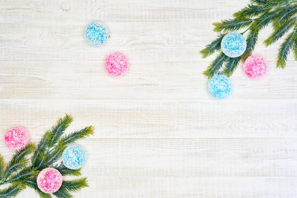 Festive composition of Christmas decorations on white wooden background.