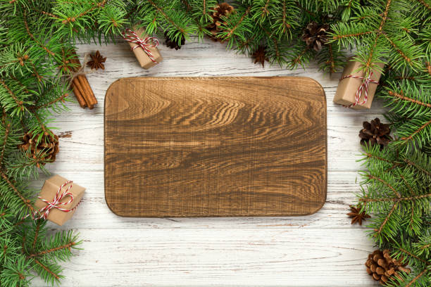 istock top view. Empty wood rectangular plate on wooden christmas background. holiday dinner dish concept with new year decor 1063736620