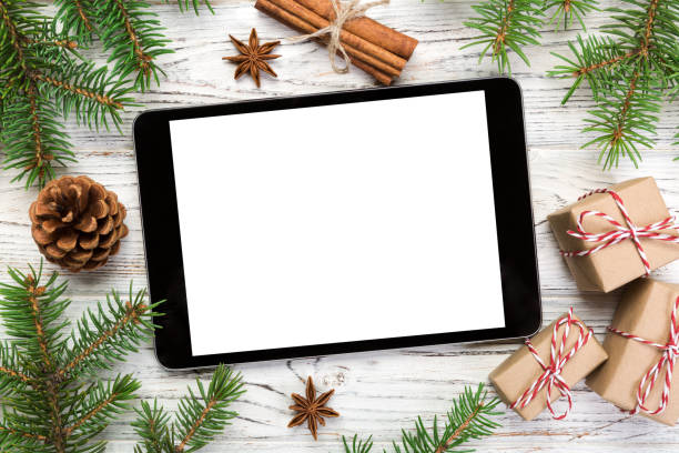 istock Digital tablet mock up with rustic Christmas wooden background decorations for app presentation. top view with copy space 1063737960