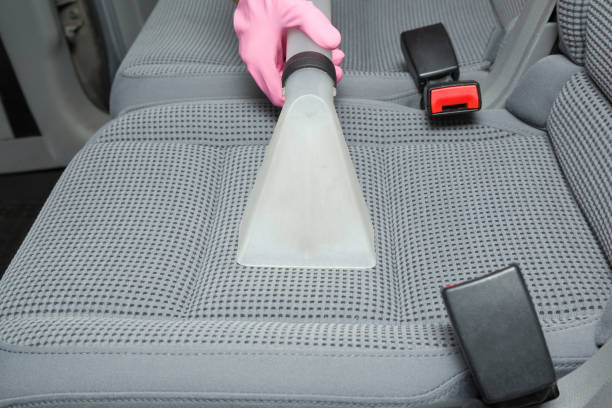 istock Cleaner hand in protective glove cleaning gray textile back passenger seat with professionally extraction method. Regular cleanup. Care about auto interior. Commercial cleaning company. Front view. 1063741946