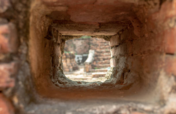 istock Blurred view through focused loophole in asian fortress brick wall 1063743250