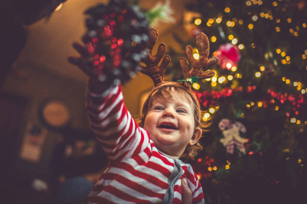 istock Cute boy near Christmas tree indoors 1063747282