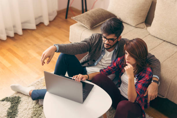 istock Couple surfing the net on a laptop computer 1063748212