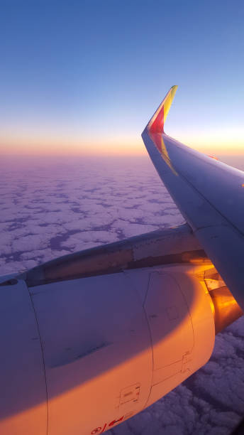 istock setting sun over the clouds - last light on the turbine of an airplane 1063752012