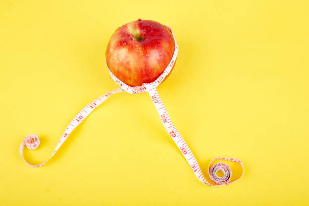 istock Measuring tape wrapped around a red apple 1063752446