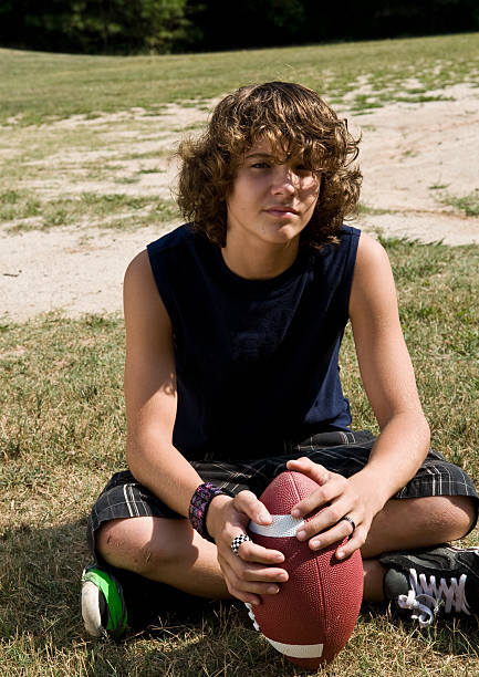 istock boy sitting with football 106375317