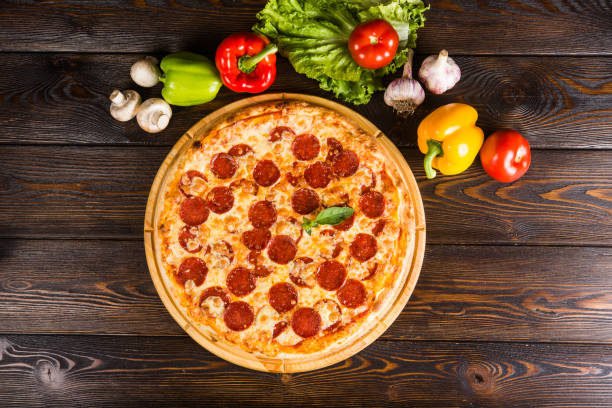 istock Italian pizza with salami, peperoni. Creative author's pizza 1063755264