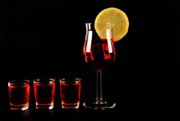 Detail of a group of glasses full of rainbow coloured liquids