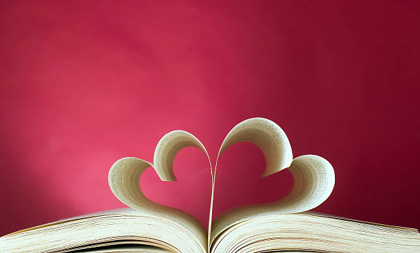 opened book and heart shape - romantic stockfoto's en -beelden