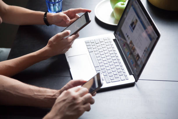 istock Young couple using smartphones, checking social networks 1063760108