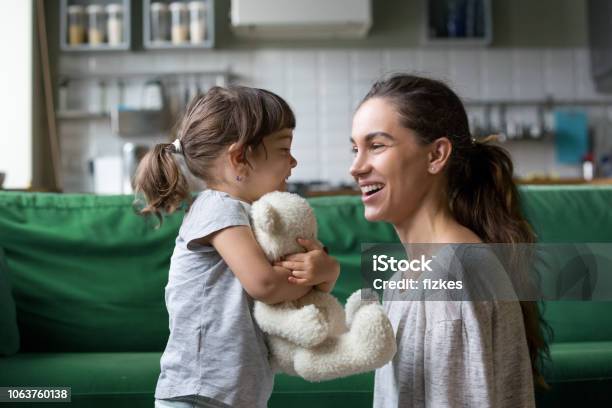 Smiling Young Mum Talking With Little Daughter Stock Photo - Download Image Now - Child, Mother, Talking