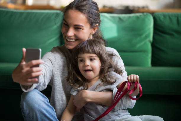 istock Happy smiling mother taking selfie with daughter 1063760200