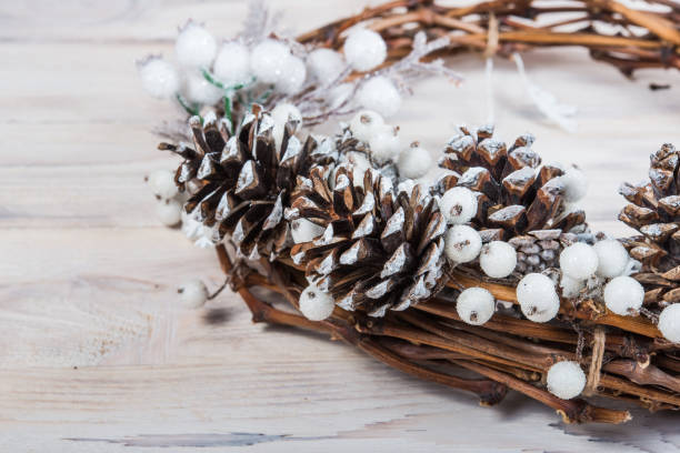 istock Macro. Christmas winter frame Christmas wreath on a white wooden background 1063764908