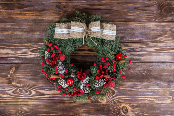 istock Christmas winter frame on dark wooden background. Christmas wreath. red elements 1063765332