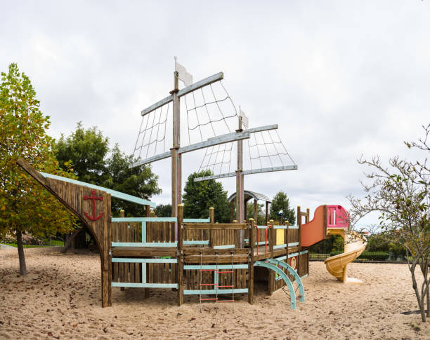 Public children's playground with a wooden boat to climb