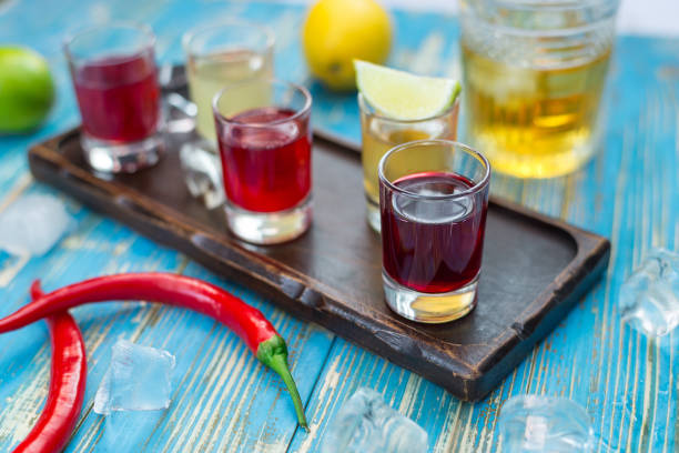 istock small glasses with colorful drinks on a wooden board 1063769216