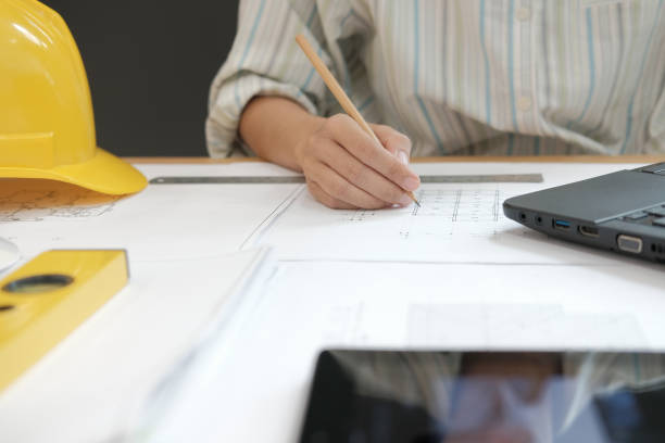 istock architect engineer working on house blueprint of real estate project at workplace. building construction concept 1063770702