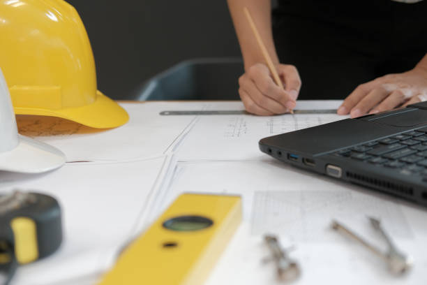 istock architect engineer working on house blueprint of real estate project at workplace. building construction concept 1063770706