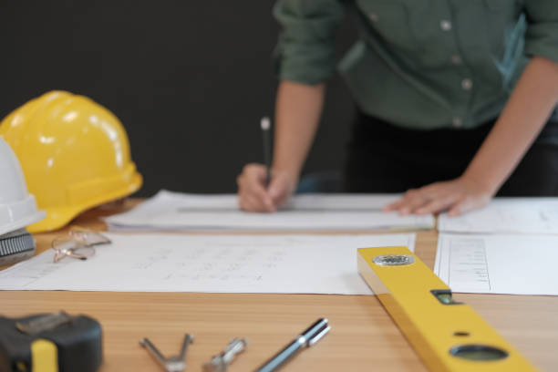 istock architect engineer working on house blueprint of real estate project at workplace. building construction concept 1063770844