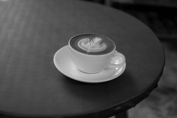 istock A white cup of coffee is placed on a gray table. 1063783456