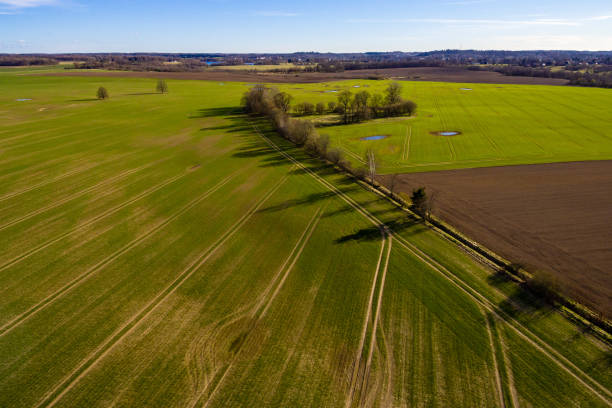 istock drone image. aerial view of rural area with fields and forests with river and water reflections 1063784946