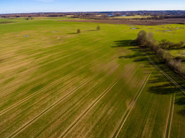 istock drone image. aerial view of rural area with fields and forests with river and water reflections 1063785120