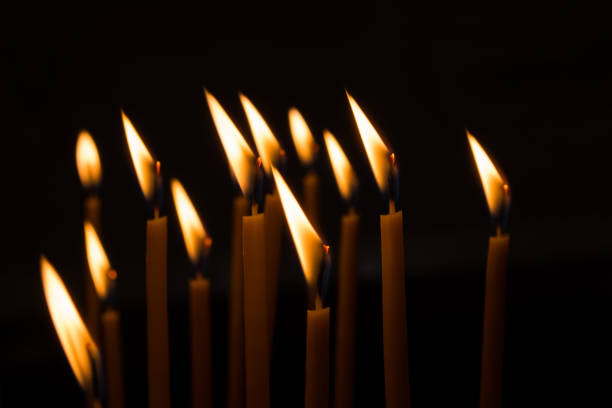 istock burning wax candles against the window in a dark room 1063785706