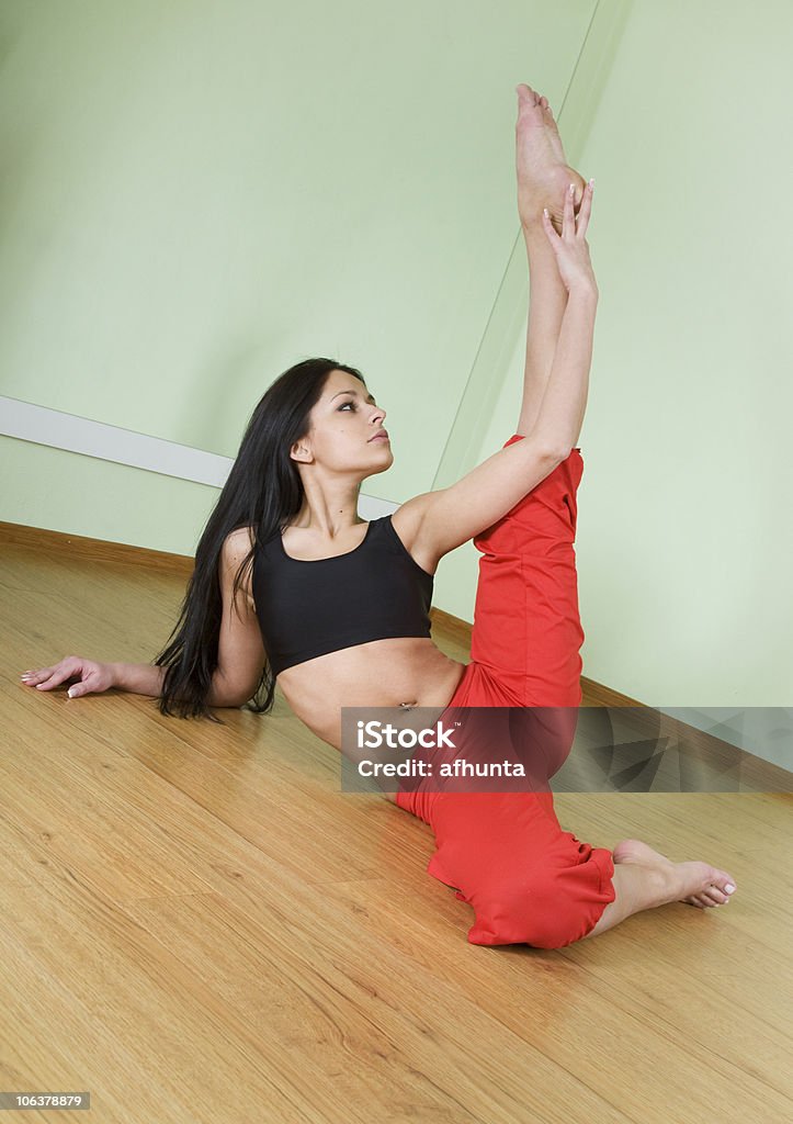 Beautiful brunette Beautiful brunette sits on the floor in the gym Activity Stock Photo