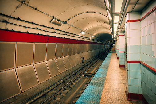 The subway station platform at T-Centralen in downtown Stockholm busy with passengers waiting as a train arrives in the station.