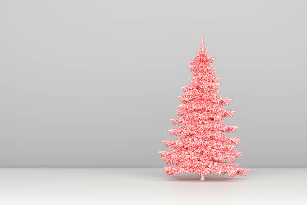 istock Conceptual image of a Christmas tree made from origami paper, standing on a white surface and gray background. 1063789652