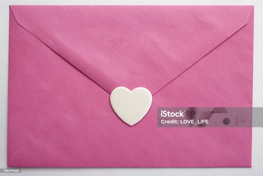 Pink envelope and heart Pink envelope and heart on white background. Anniversary Stock Photo