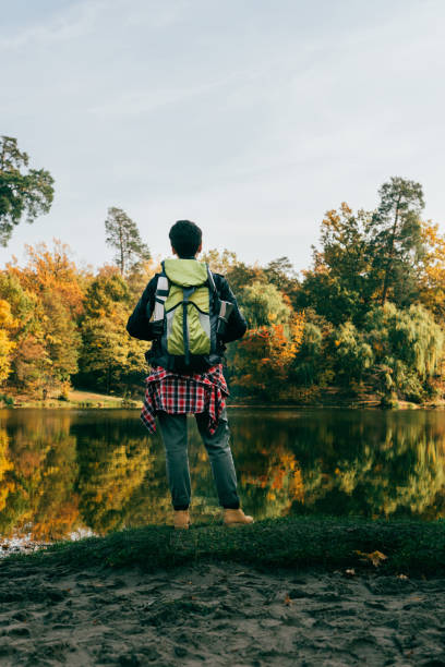 istock rear view of traveller with backpack on autumnal background 1063792750