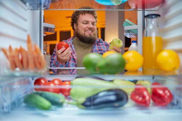istock Man choosing what to eat late at night. 1063792808