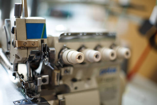 istock closeup details on sewing machine overlock. Workplace seamstress.Tailoring industry. 1063794244