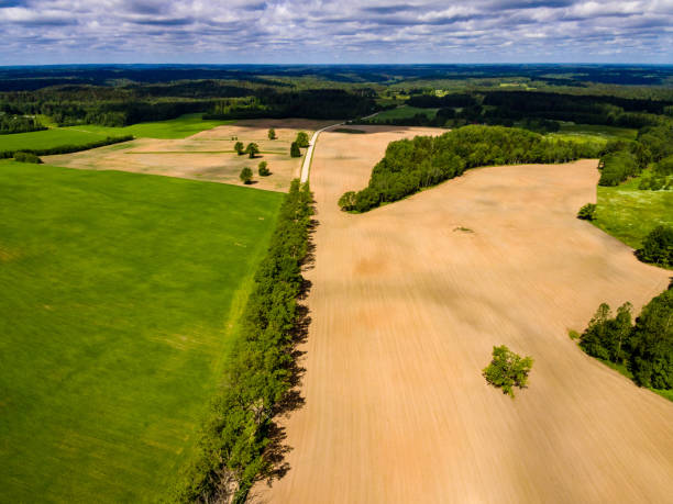 istock drone image. aerial view of rural area with fields and forests with river and water reflections 1063796106