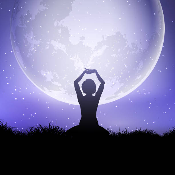 istock Female in yoga pose against a moonlit sky 1063796358