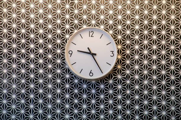istock white clock decorate on ceramic seamless wall, it is twenty five past nine in morning. 1063797112